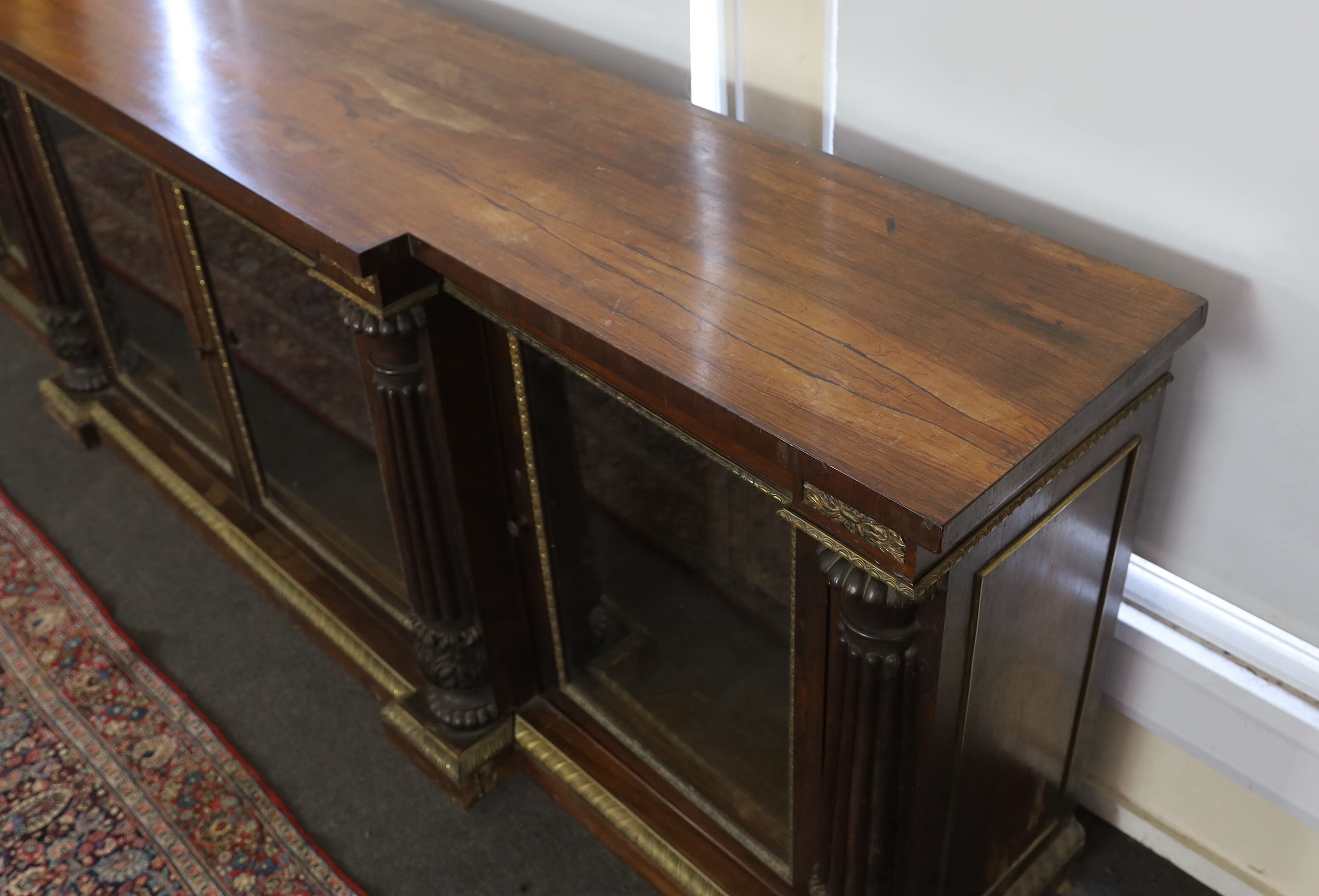 A George IV ormolu mounted rosewood breakfront dwarf bookcase, width 306cm, depth 60cm, height 102cm